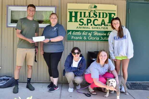 Reese Felty presents a check to Hillside SPCA Shelter Manager Sherrie Shafer on behalf of the Schuylkill Haven Area High School Biology Club. Felty was joined by Hayley Lenhart, Katelynne Tolar and Saragrace Minnig. The dog is Stumpy, anxiously awaiting adoption. (Submitted photo)